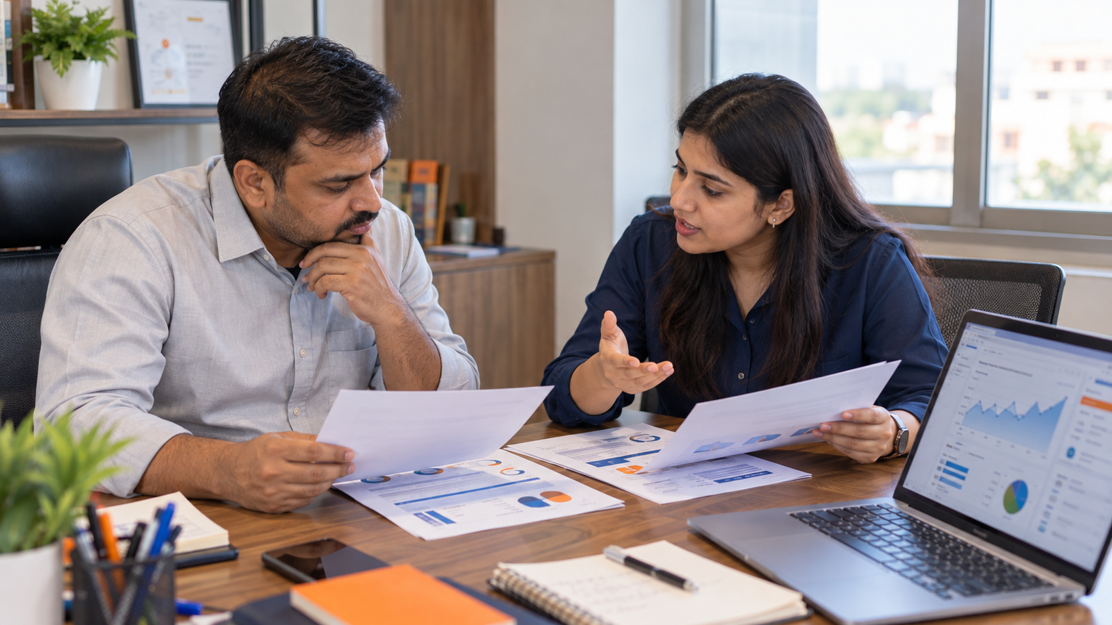 ndian business owner comparing SEO agency proposals, pricing and performance reports with a marketing consultant.